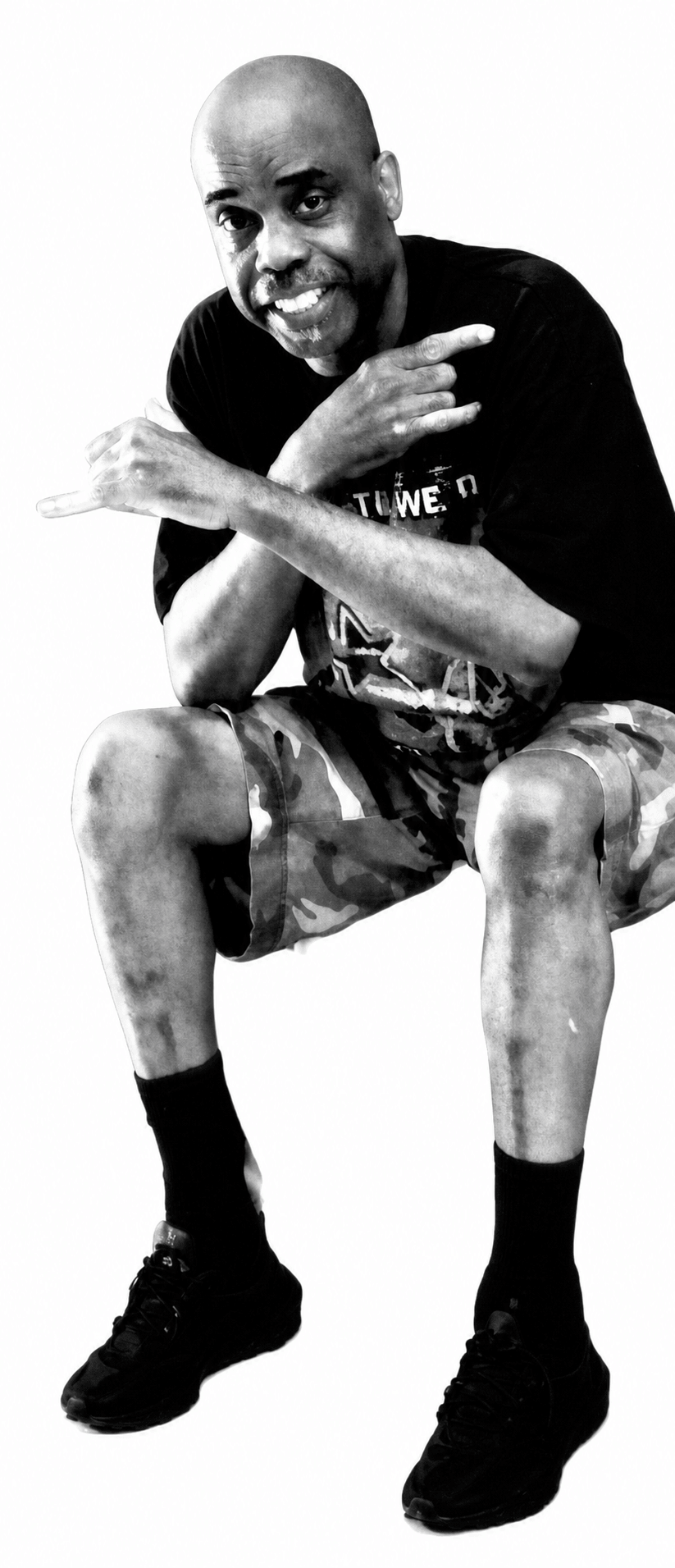 Pervis Polk smiling and gesturing with both hands